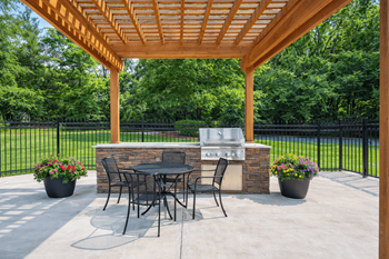 Covered patio with outdoor dining and built in grill